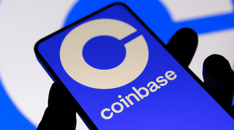Coinbase Launches Monthly Token Sale Platform, Taps Monad for First $187 Million Offering hand holding phone with coinbase logo